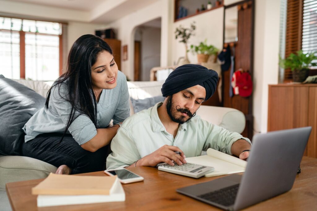 Couple using a wedding budget calculator on a laptop — Las Vegas wedding budgeting tips