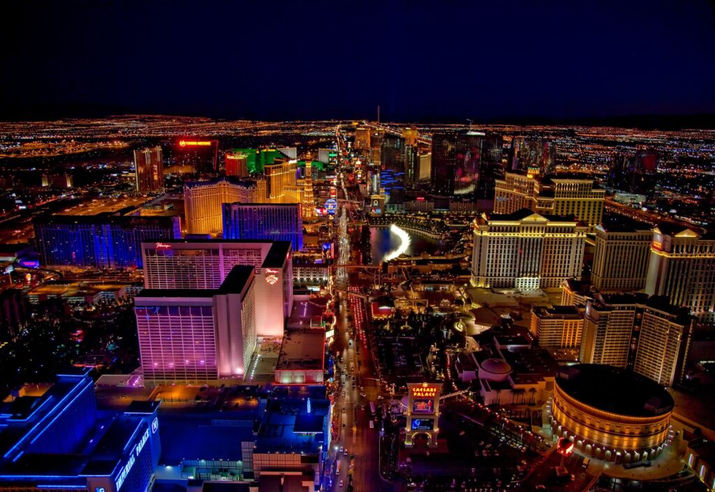 Couples taking wedding photos on the Las Vegas Strip at sunset. — Las Vegas wedding traditions