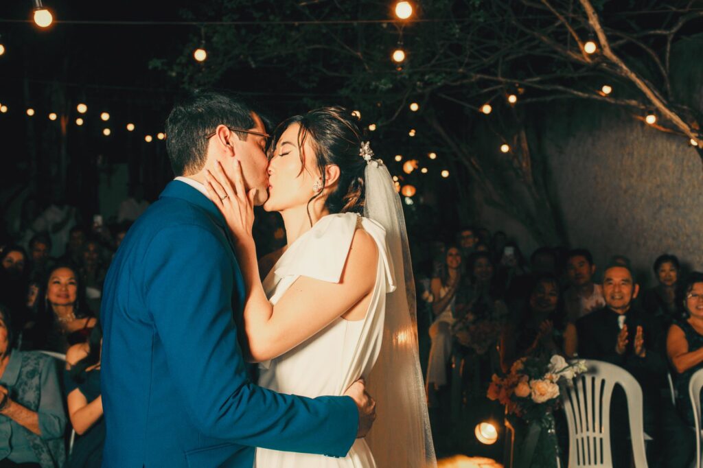 Guests enjoying a reception under string lights at an outdoor venue. — outdoor wedding venues Las Vegas