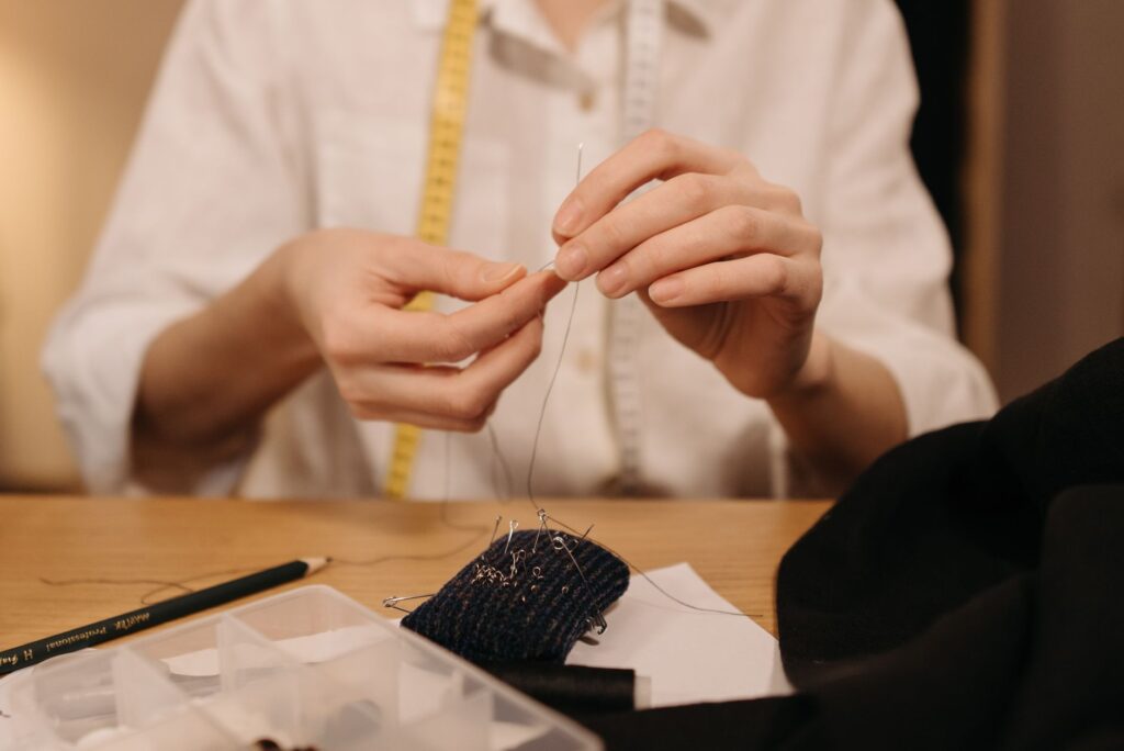 A bride having her dress altered by a skilled tailor in a cozy workspace. — Las Vegas wedding dress tips