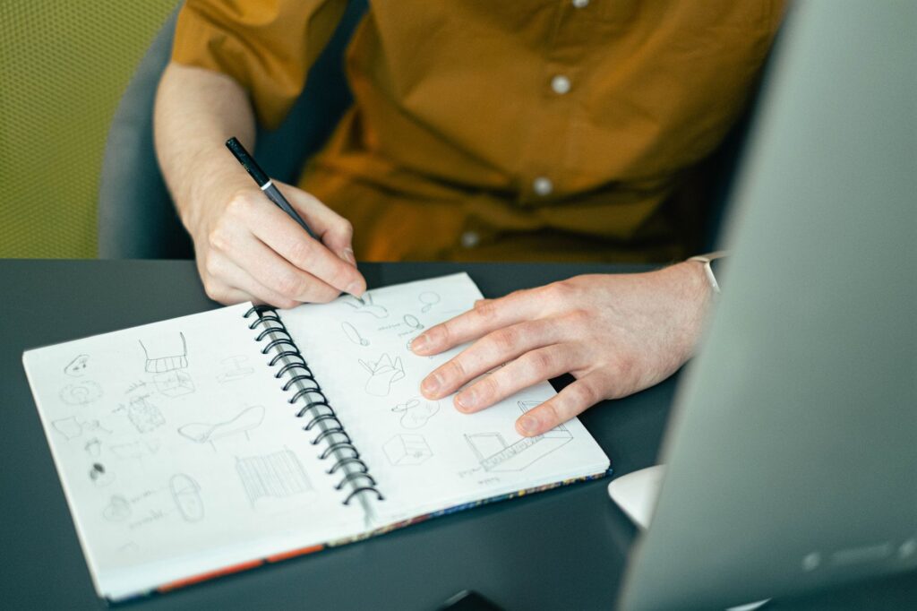 A close-up of a wedding planner's notebook filled with ideas and sketches. — questions for Las Vegas wedding planner