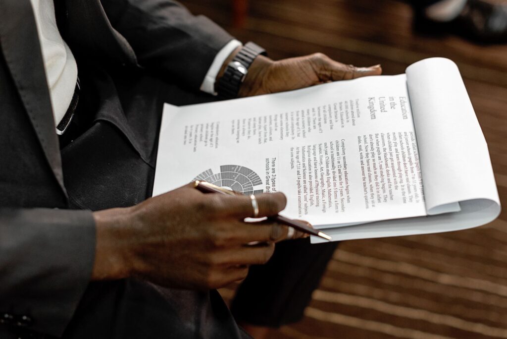 A close-up of wedding planning documents being reviewed by a concierge. — questions for wedding concierge