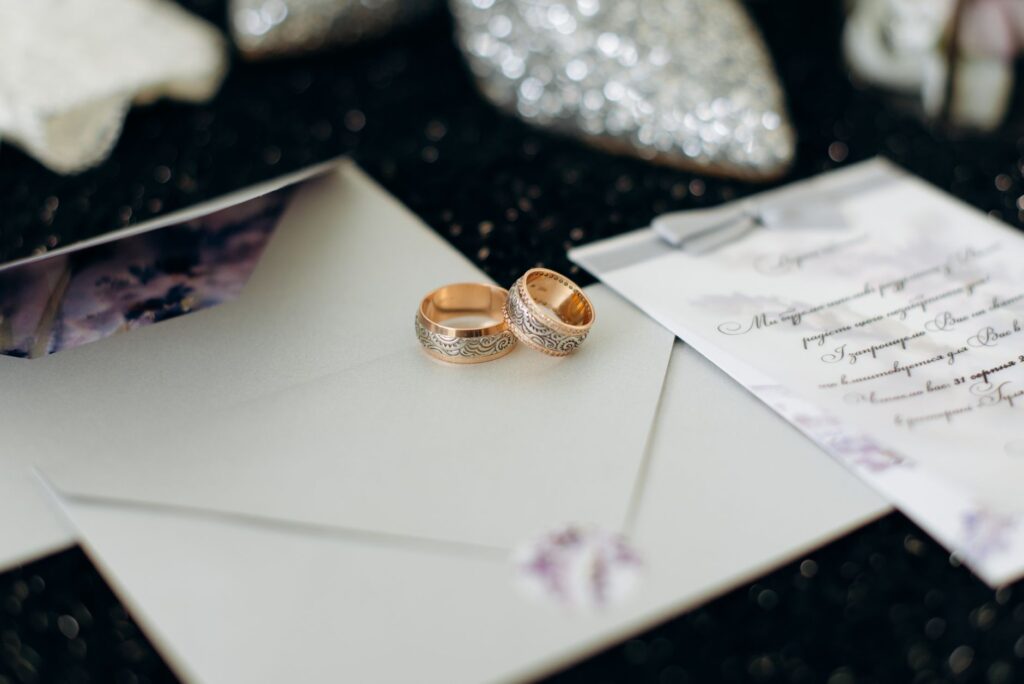 A close-up of wedding rings on a wedding invitation. — wedding package Las Vegas