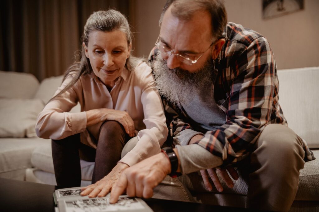 A happy couple looking at their wedding album with their photographer. — best wedding photographers Las Vegas